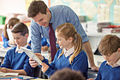 Teacher with his pupils using tablet pc