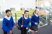 Happy pupils in school corridor