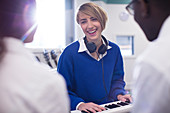 Smiling students playing synthesizer