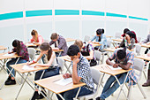 Students writing their GCSE examination