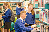 Students using computer in library
