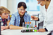 Teacher and students in chemistry lesson