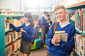 Smiling male student in library