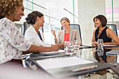 Businesswomen sitting at conference table