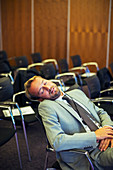 Businessman sleeping in conference room