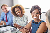 Smiling woman sitting at conference table