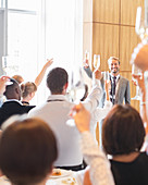 Smiling man standing before audience