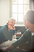 Men relaxing together in living room