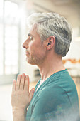 Close up of older man meditating