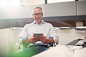 Businessman using tablet at office desk