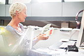 Businesswoman examining paint swatches