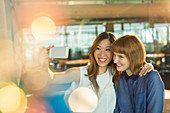 Businesswomen taking cell phone selfie