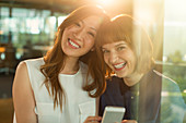 Businesswomen using cell phone in office