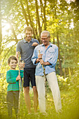 Boy, father and grandfather in forest