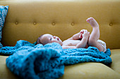 Little baby lying on blue cloth