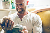 Portrait of father holding baby