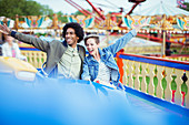 Cheerful couple on carousel