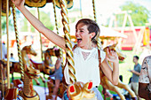 Cheerful woman on carousel