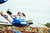 Couple enjoying ride on carousel