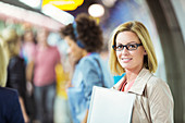 Businesswoman smiling in train station