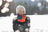 Portrait of smiling woman in snow