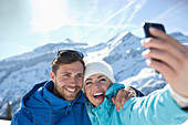 Couple taking selfie in snow