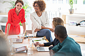 Office workers talking at desk