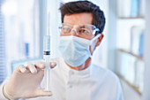 Man in surgical mask and labcoat