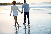 Young couple holding hands and walking