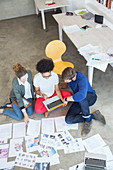 Three young people working in studio