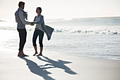 Young couple holding hands on beach