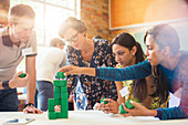 Business people stacking green blocks