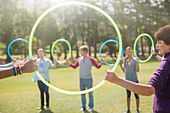 Team connected in circle by plastic hoops