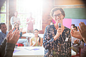 Audience clapping for woman