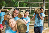 Determined team carrying logs