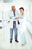 Doctors with medical charts consulting