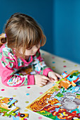 Girl assembling jigsaw puzzle