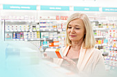 Customer reading label on box in pharmacy