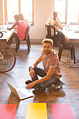 Businessman working on laptop on floor