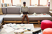 Businesswoman typing on tablet in office