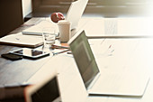 Laptops, tablet and paperwork on table