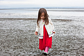 Girl in dress walking on beach