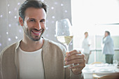 Man drinking white wine in restaurant