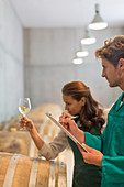Vintners examining white wine