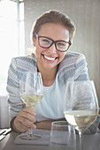 Woman with eyeglasses drinking white wine