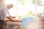 Masseuse massaging woman's legs