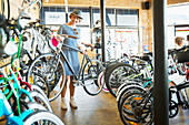 Woman selecting bicycle from rack