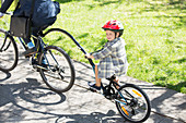 Boy riding with businessman father