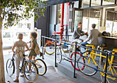 People with bicycles at urban cafe