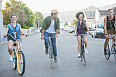 Friends riding bicycles in a row